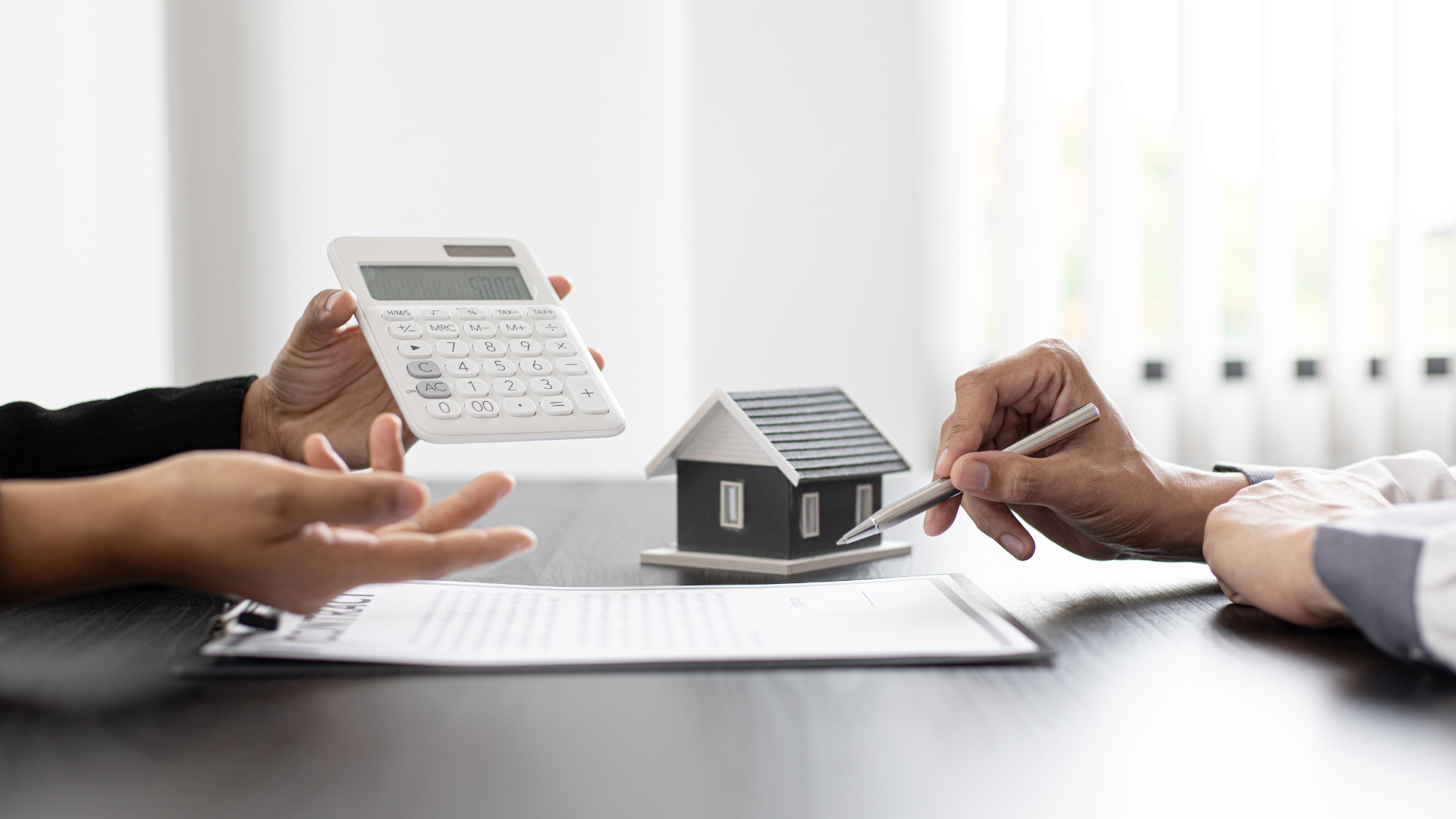 home financing image with calculator and house